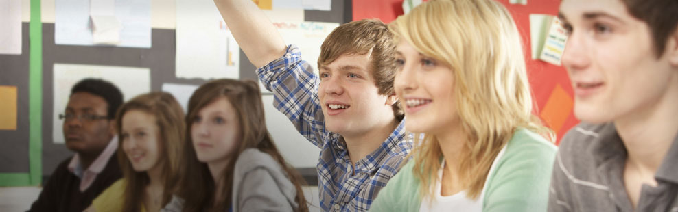 High school students in a ZAPS seminar are paying close attention to the presenter. One student has his hand raised.